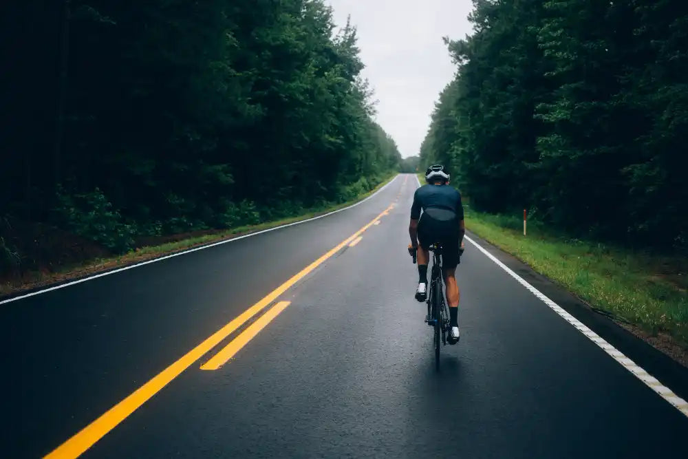 Cyclist on wet road.