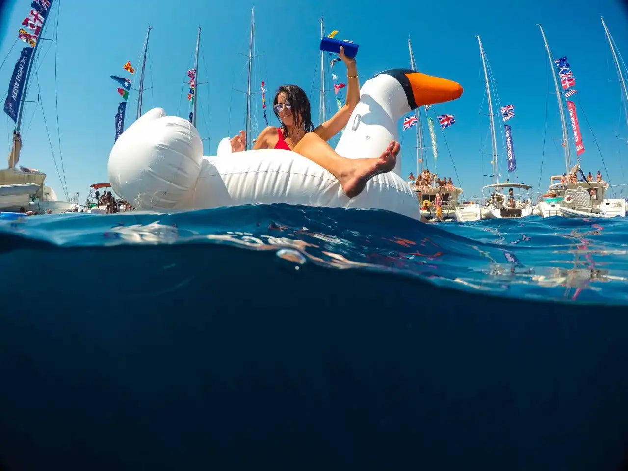 Woman on inflatable swan.